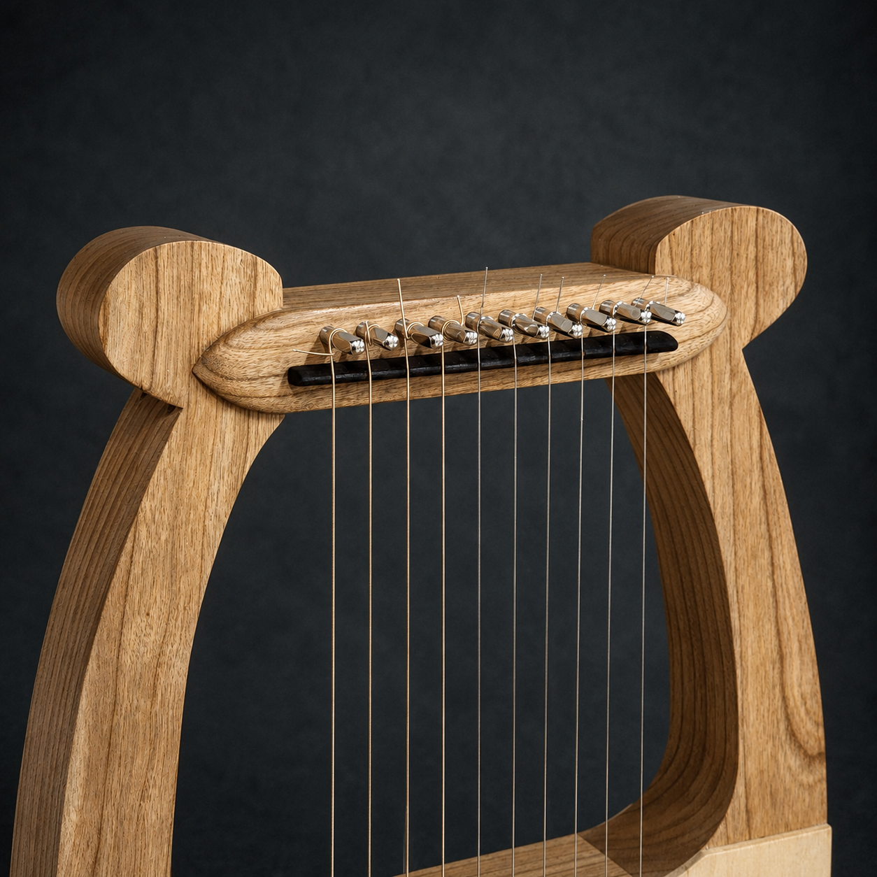Close-up of the tuning pins, strings, and handcrafted upper frame of David’s Harp