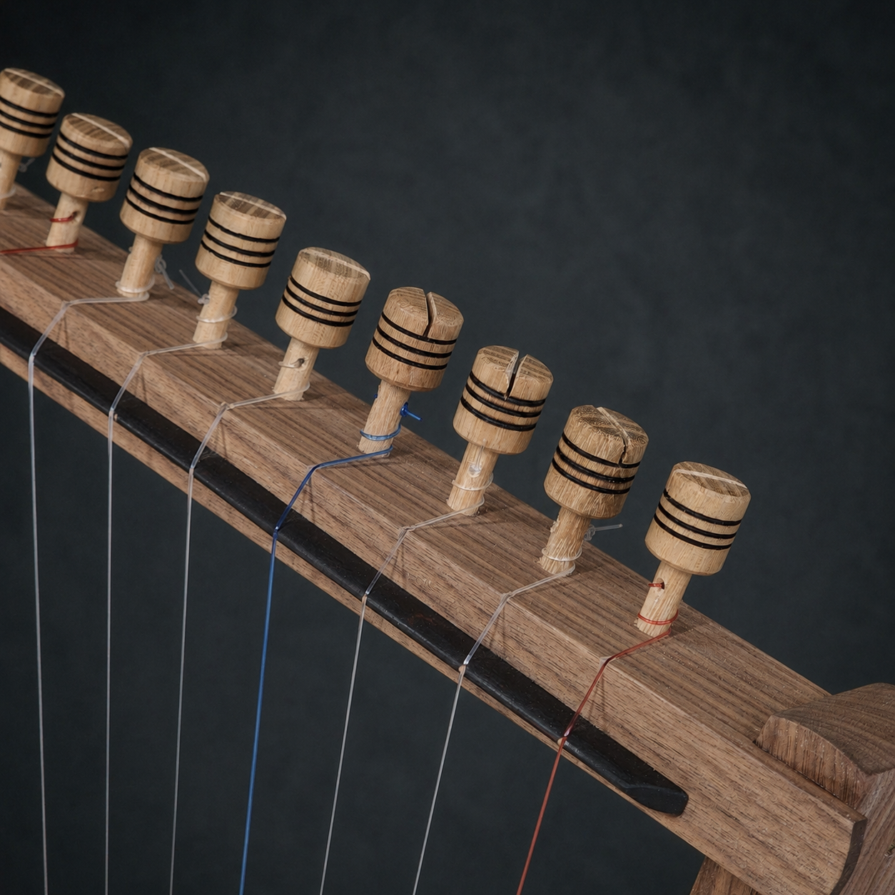 Close-up of the hand-carved wooden tuning pegs on the 10-string Megiddo Harp